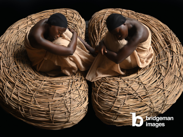 photograph of two black women in two nests