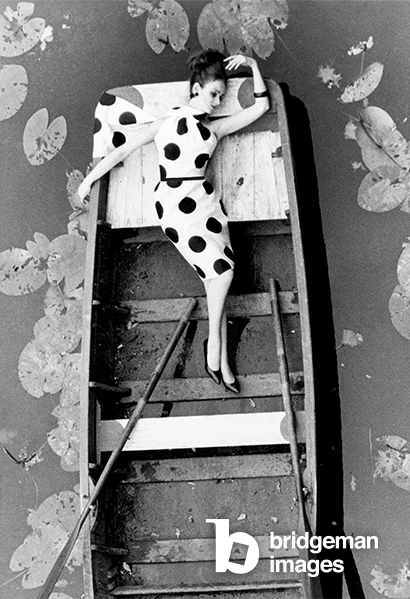 Model posing in a boat wearing a white dress with large black dots, 1960s (b/w photo), John Cole, (1923-95) / Private Collection / © John Cole Archive. All rights reserved 2022 / Bridgeman Images.jpg