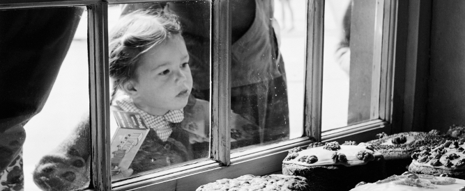 View looking out through Clare's Cake Shop window whilst a young girl looks in at the display of cakes, 1956 (b/w photo), John Gay, (1909-99) / Padstow, Cornwall, UK / © English Heritage. NMR