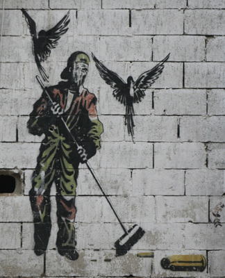 Graffiti depicting a man sweeping bullets, 2010, Liban, Lola Claeys Bouuaert
