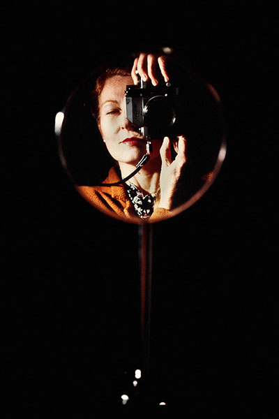 photo of Maria Mulas taking a self portrait in a round mirror